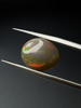 Opal ciemny naturalny kaboszon owal 13,61 x 11,45 mm